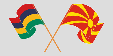Crossed and waving flags of North Macedonia and Mauritius
