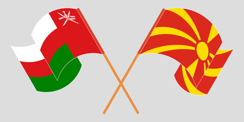Crossed and waving flags of North Macedonia and Oman
