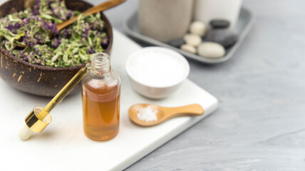 Bottle natural organic oil essence serum with healing herbs and sea salt. Aromatherapy and beauty. Concept set of harmony, balance and meditation, spa, massage, relax, beauty spa treatment.