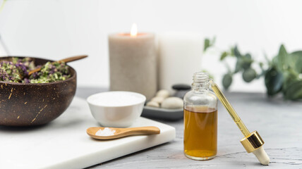 Bottle natural organic oil essence serum with healing herbs and sea salt. Aromatherapy and beauty. Concept set of harmony, balance and meditation, spa, massage, relax, beauty spa treatment.