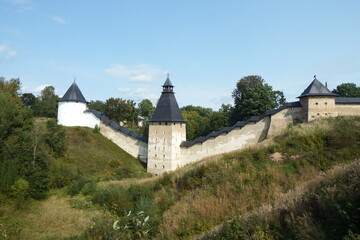 Autumn in Pskov Pechora monastery: walls, towers, plants