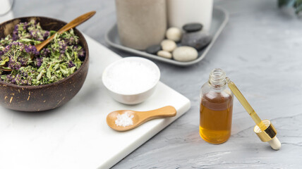 Bottle natural organic oil essence serum with healing herbs and sea salt. Aromatherapy and beauty. Concept set of harmony, balance and meditation, spa, massage, relax, beauty spa treatment.