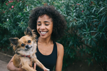 Cheerful woman with dog in park