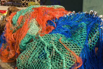 colorful nets and rusty fishing gear on a quay in the harbor of Ostend, Belgium