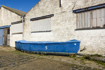Fototapeta na wymiar old lifeboat on a quay in Ostend