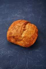 Bakery - gold rustic crusty loaves of bread and buns on blue chalkboard background.