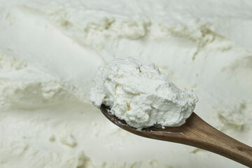 Turkish strained yogurt on wooden spoon