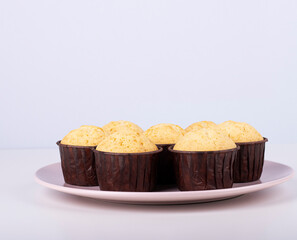 cupcakes in brown packaging on a plate