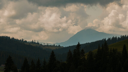 Amazing mountain landscape with varied weather, overcast sky, evening time. Bukovel Carpathians, Ukraine. Natural outdoor travel background.