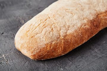 Bakery - gold rustic crusty loaves of bread and buns on grey chalkboard background.