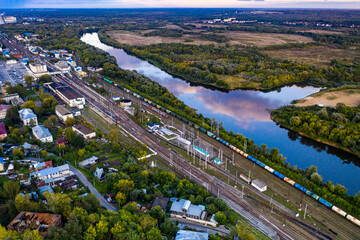 Fototapeta premium panoramic view of the motorway across the river against the backdrop of a green forest