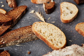 Bakery - gold rustic crusty loaves of bread and buns on grey chalkboard background.