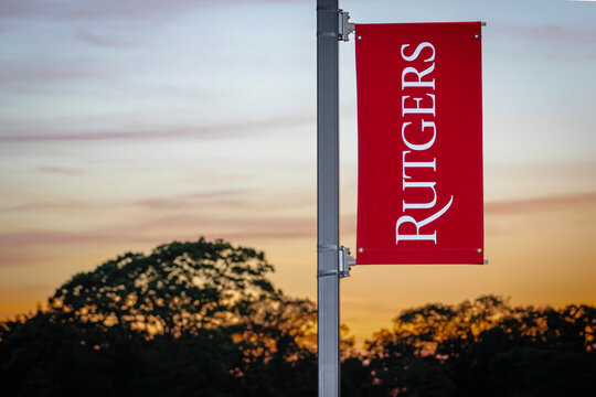 Rutgers University logo on banner against colorful skies