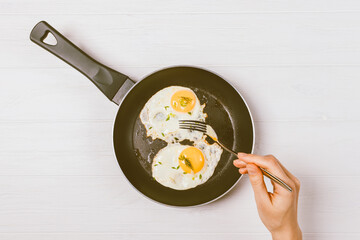 Overhead view female's hand holding fork