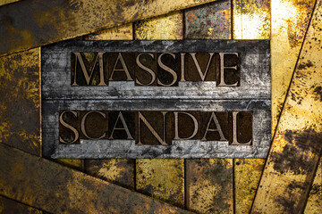 Massive Scandal text message on textured grunge copper and vintage gold background