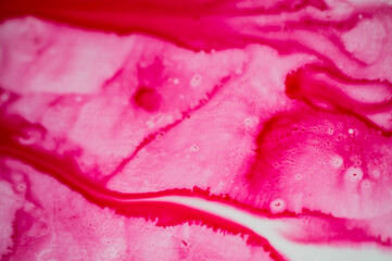 Spilled ink for refilling cartridges. Pink background. Pink abstraction.