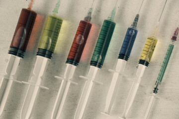 Colorful medical needle with chemical drugs and vaccine