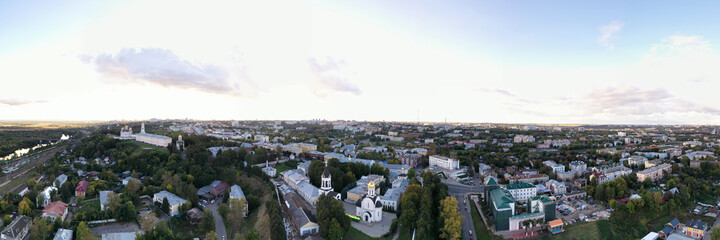 a panoramic view of the old city district with ancient buildings and a church filmed from a drone