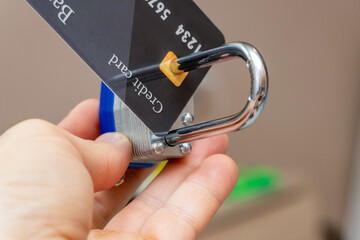 Locked with metal padlock plastic credit card close up