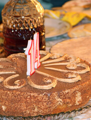 Chocolate cake with cipher fourteen for teenager. Birthday cake on table