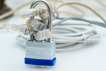 bundle of network wires blocked with metal padlock on white background