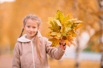 Naklejka na ściany i meble Adorable little girl at beautiful autumn day outdoors