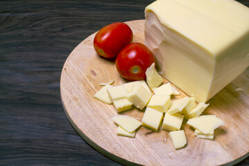 Cheese board and tomatos. Ingredientes for pizza. Seletive focus