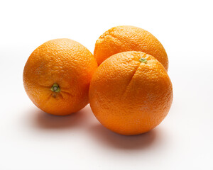 threesome oranges  on white background, supermarket presentation, slightly above camera shoot