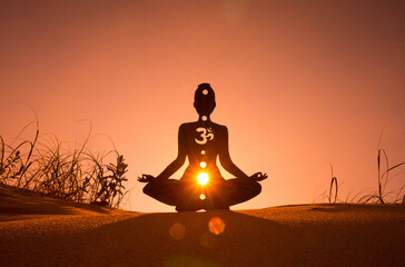 Silhouette of a person doing yoga with the root chakra symbol - obrazy, fototapety, plakaty