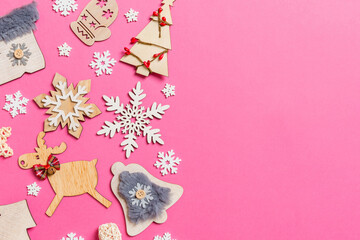 Top view of holiday decorations and toys on pink background. Christmas ornament concept with empty space for your design