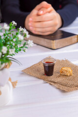 Young woman praying and Taking communion  - the wine and the bread symbols of Jesus Christ blood and body with Holy Bible