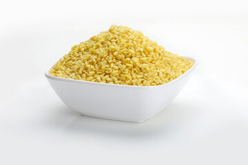 Indian snacks roasted mung dal in white bowl in white background.