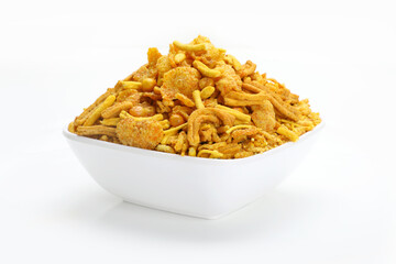 Mixture chivda Indian snacks or namkeen in white bowl in white background.