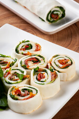 .Buffalo mozzarella roll stuffed with dried tomatoes and arugula.