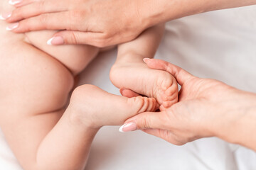Close-up Foot massage for baby. Mother makes massage for happy, Health care concept