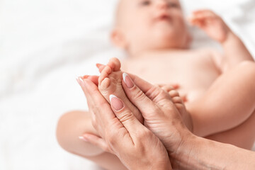 Mother massaging her child's foot, Foot massage for baby. Health care concept