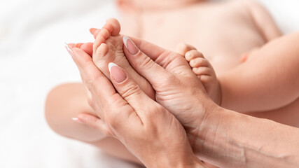 Mother makes massage for happy baby, Masseur massaging little baby's foot