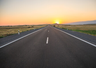 asphalt road with sunset