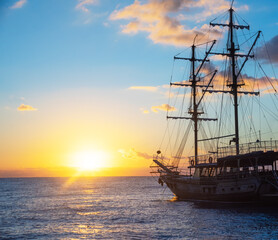 Fototapeta na wymiar Old Ship expedition at sunrise. Travel and freedom concept.