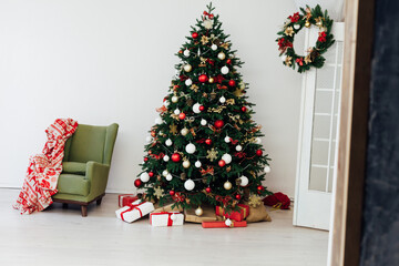Christmas tree with gifts for the new year in the interior of the white room