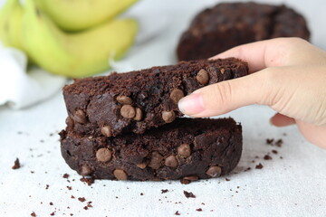 Taking a slice of homemade chocolate banana bread
