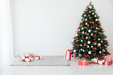 Christmas tree with gifts for the new year in the interior of the white room