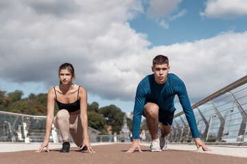 Man and woman making sport training outdoors together