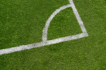 Fototapeta premium Green artificial grass turf soccer football field background with white line boundary. Top view