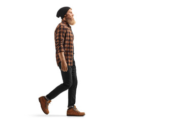 Full length profile shot of a hipster guy with beard and mustache walking