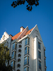 View on the top of building with orange roof in the blue sky