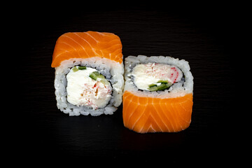 Sushi and rolls on a black