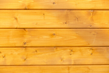 Fototapeta premium Wooden background. Wooden planks, lining, boards for construction works in the sawmill.