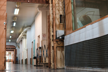 Old prison corridor or aisle with warden or supervisor booth. Controlled access in jail.