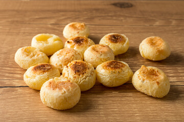 Traditional Brazilian Snack Cheese Bread. On a wooden table background